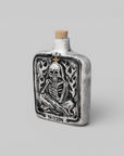 Neighborhood Bottle Incense Chamber Black — front view of ceramic vintage-style bottle with raised skull in flames motif, gold cross detail and cork stopper.