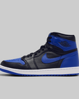 A classic high-top sneaker in black and royal blue leather with a white midsole, shown from the side against a solid gray background.