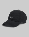A black Y-3 dad cap made of cotton with a metal closure on the back, featuring the Y-3 logo on the front.