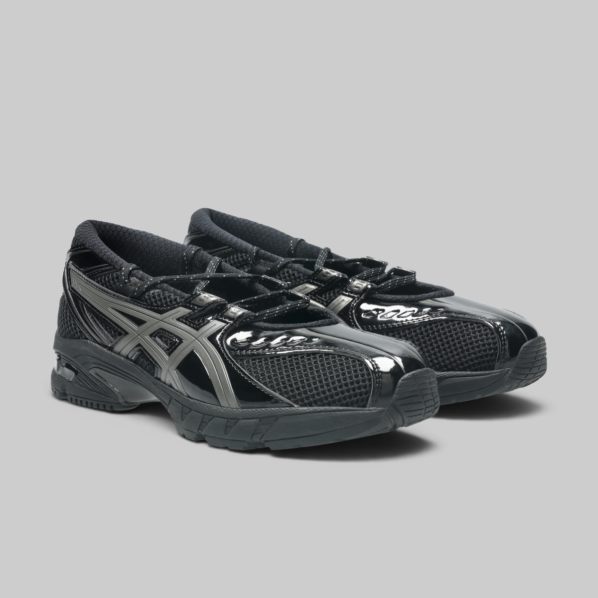 Black running shoes with visible branding on a white background