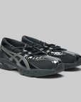 Black running shoes with visible branding on a white background