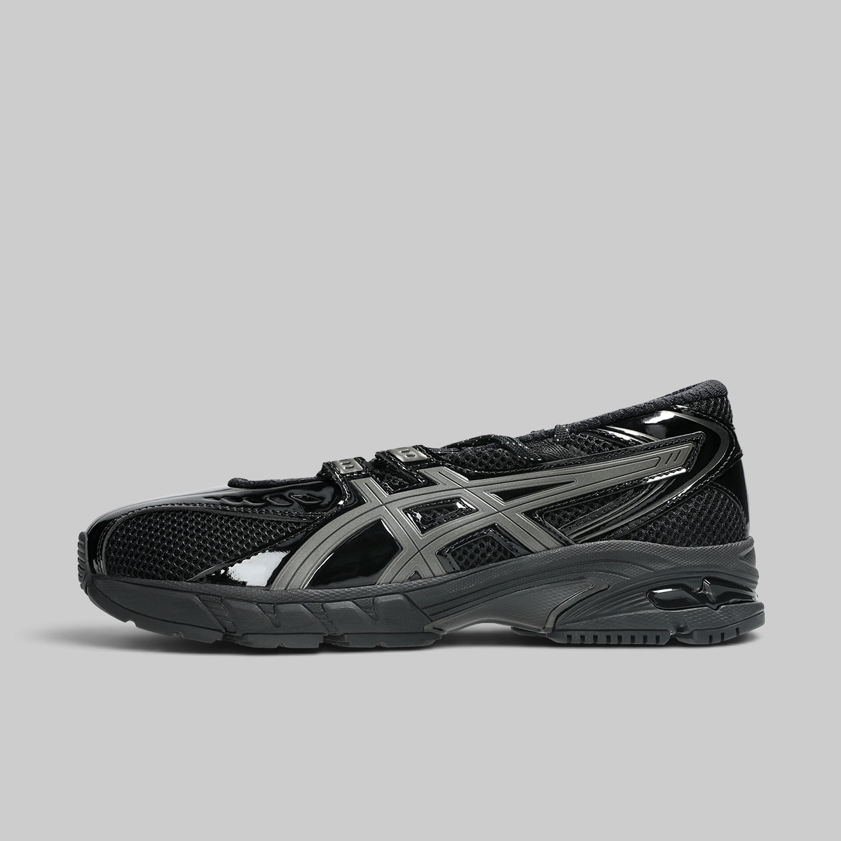 Black soccer shoe with visible branding on a white background