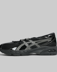 Black soccer shoe with visible branding on a white background