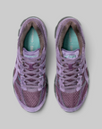 A pair of Asics running shoes in a dusty purple colorway, shown from a top-down view on a neutral gray background.