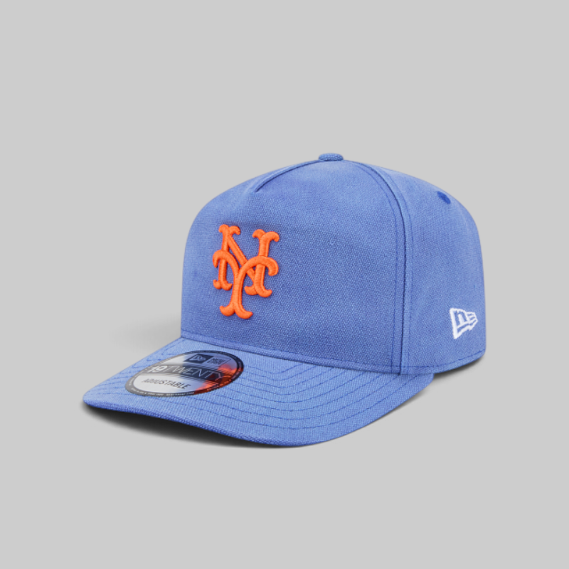 A blue New York Mets fitted baseball cap by New Era, featuring an orange embroidered 'NY' logo on the front and a white New Era flag logo on the side, set against a solid gray background.