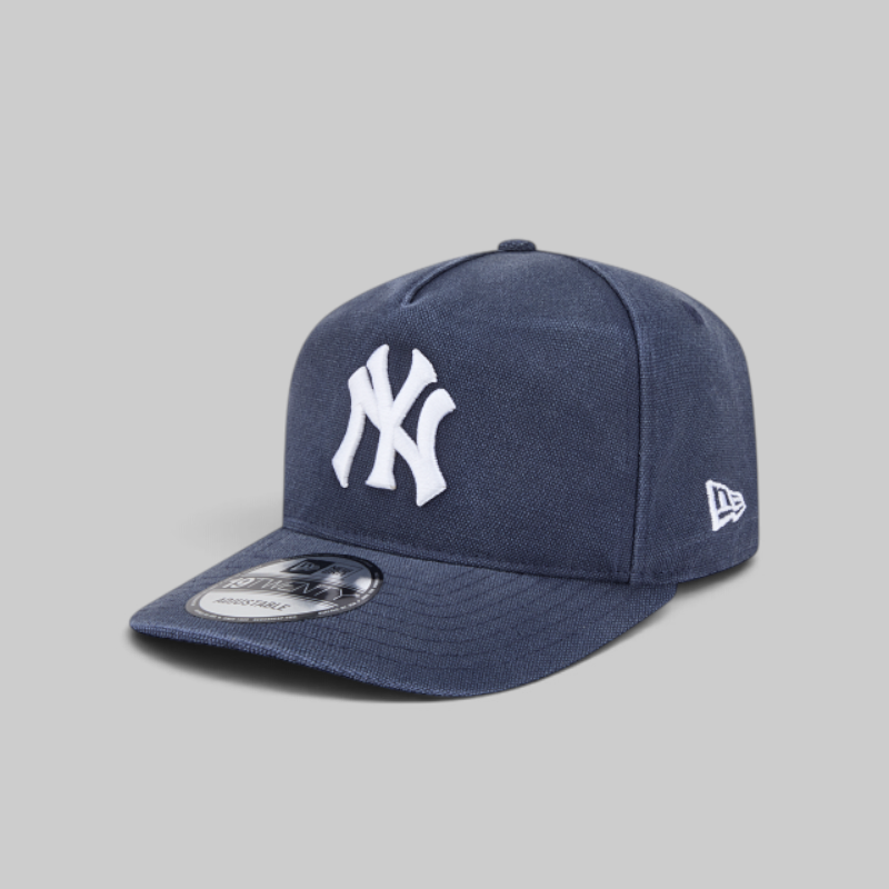 A navy blue New York Yankees fitted cap with a white embroidered NY logo on the front and a white New Era flag logo on the side, shown on a neutral gray background.