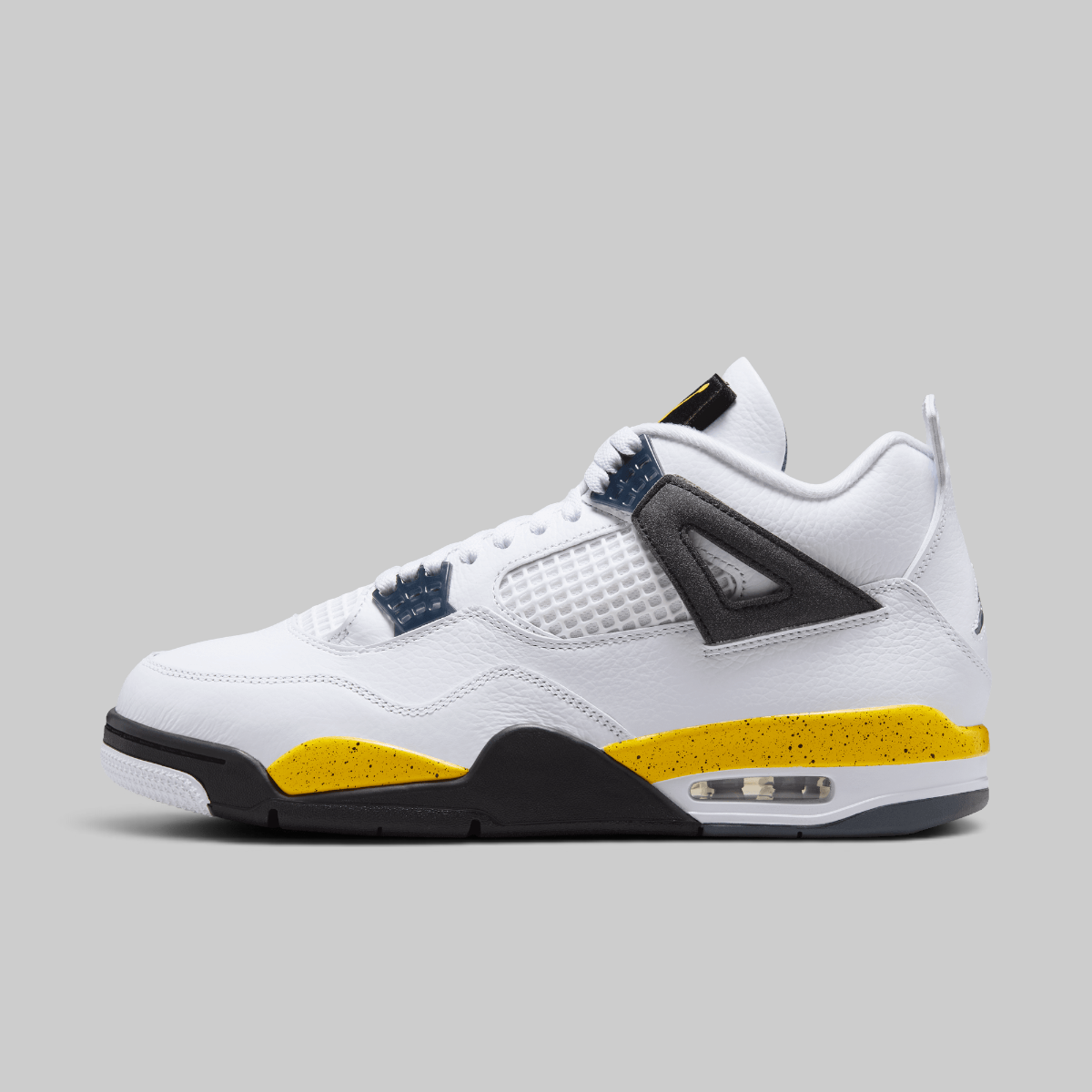 A white Air Jordan 4 sneaker with a black and yellow speckled midsole, navy blue lace wraps, and a black ankle strap, shown in a side profile on a solid gray background.