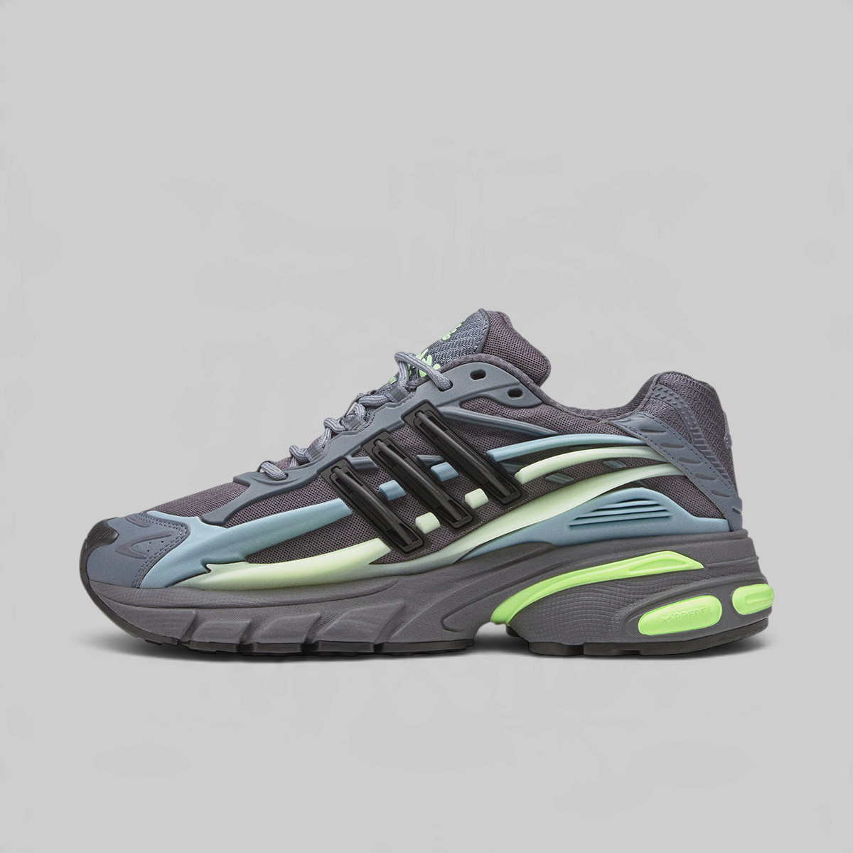 A single Adidas sneaker shown in profile against a solid light gray background. The shoe features a dark gray and black upper with light blue overlays, a pale yellow-green midsole accent, and a bright neon green outsole.