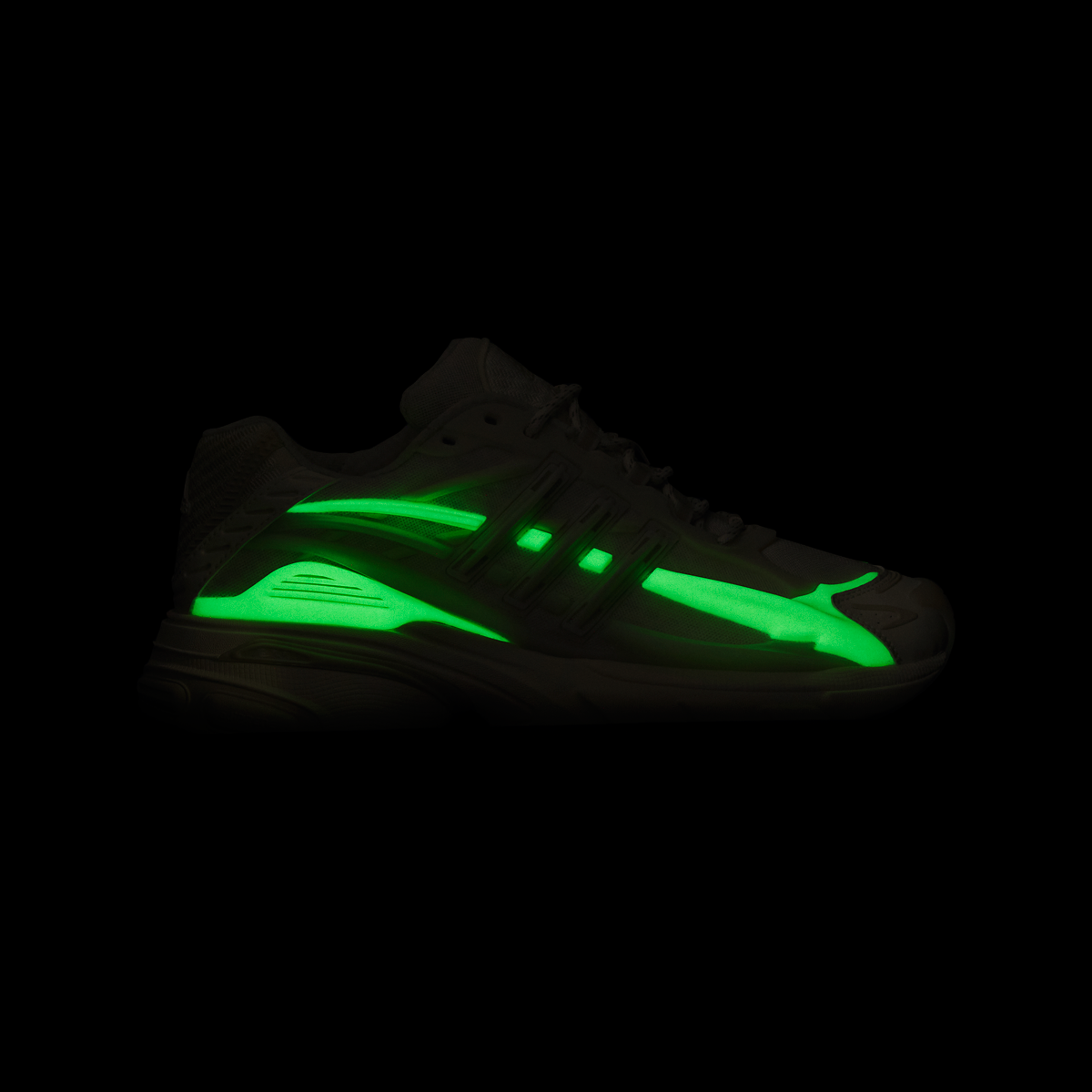 Pharrell Williams Adistar Jellyfish - "Crystal Sand" sneaker glow in dark neon green side stripe and matching green accents on the midsole, shown in profile against a solid black background.