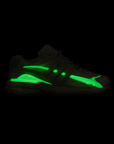 Pharrell Williams Adistar Jellyfish - "Crystal Sand" sneaker glow in dark neon green side stripe and matching green accents on the midsole, shown in profile against a solid black background.