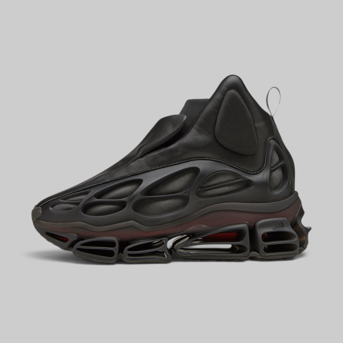A single black high-top sneaker with a sculpted, bubble-like upper and a thick, sculptural sole featuring visible air-like chambers, photographed on a plain light gray studio background.