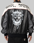 Back view of a person wearing a black and off-white leather jacket with a large white skull graphic on the back and the words 'TITAN STREES' across the shoulders, paired with black pants against a light gray background.