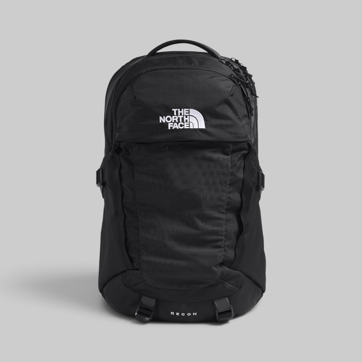 A black The North Face Regum backpack with a white logo on the front, shown against a solid gray background.