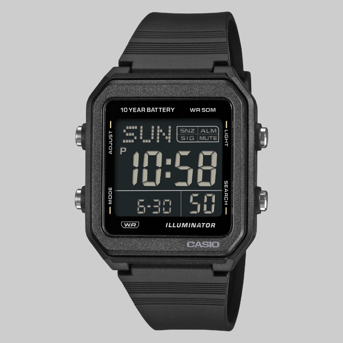 A Casio digital wrist watch with a rugged black rectangular case and a matching black textured strap, shown against a solid gray background.
