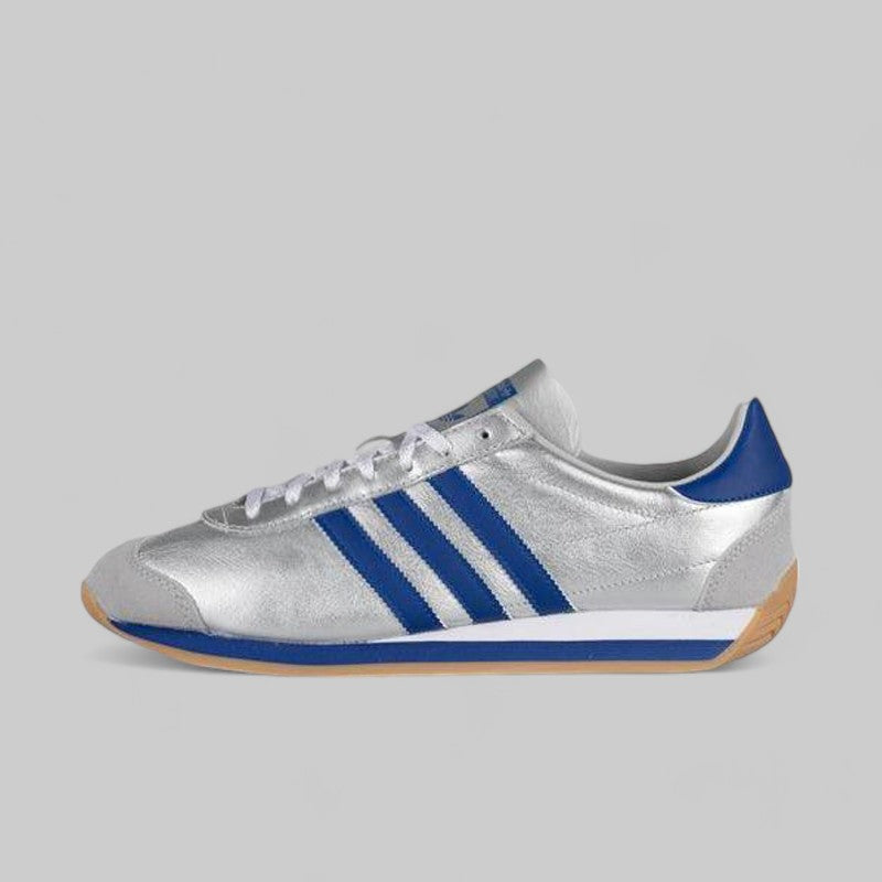 A matte silver and bright blue adidas running shoe with three stripes and a low-profile build.
