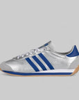 A matte silver and bright blue adidas running shoe with three stripes and a low-profile build.