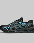 A black ASICS Gel-Kayano running shoe with bright blue accents on the side stripes and overlays, shown in a side profile against a solid gray background.