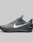 A Nike basketball shoe in dark gray with a white Swoosh logo and a translucent heel counter showing a multicolor iridescent insert, set against a solid gray background.